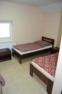 A bed or beds in a room at Reštaurácia-penzión ALTANA