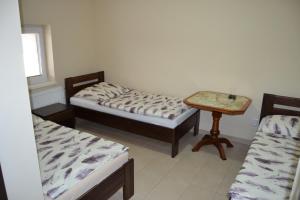 A bed or beds in a room at Reštaurácia-penzión ALTANA