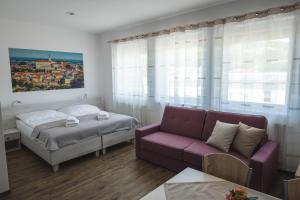 A bed or beds in a room at Apartmány Pemag Mikulov
