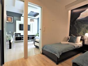 a bedroom with a bed and a living room at VIP Apartamenty Jagiellonska 33a in Zakopane
