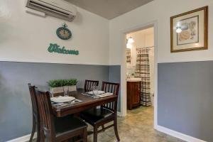 a dining room table with chairs and a clock on the wall at Drake Cottage 311 in Bend +20 photos