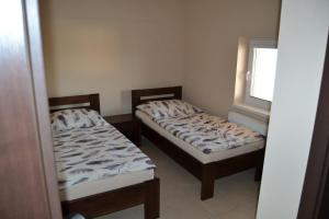 A bed or beds in a room at Reštaurácia-penzión ALTANA