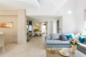 a living room with a couch and a table at Peris Villa in Kato Daratso