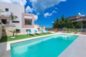 a swimming pool in the backyard of a villa at Peris Villa in Kato Daratso