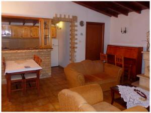 a kitchen and living room with a couch and a table at Andronikis House in Sykia Chalkidikis