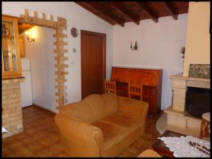a living room with a couch and a fireplace at Andronikis House in Sykia Chalkidikis