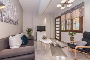 a living room with a couch and a tv at Valentine's Modern Apartment in Zakynthos Town