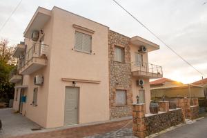 a house with two balconies on the side of it at Tasos Rooms in Stoupa