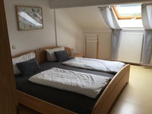 a bedroom with two beds in a room at Haus am Waldrand in Birkenhördt