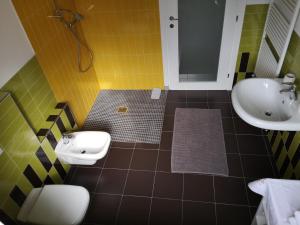 a bathroom with a sink and a toilet and a sink at Bed And breakfast Il Ghiro in Cedrasco