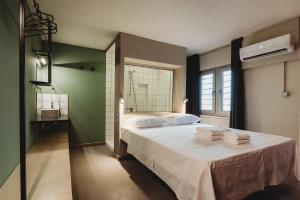 a bedroom with a bed with towels on it at eins rooms - city center in Limassol