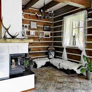 a living room with wooden walls and a fireplace at Górska Latarnia in Miedzygorze