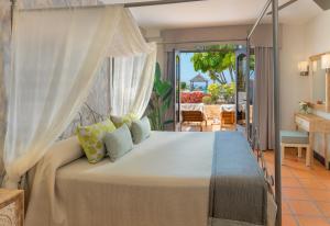 
a bedroom with a bed and a window at Regency Country Club, Apartments Suites in Playa de las Americas
