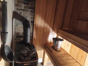a stove with a pile of rocks in a room at Ele kodumajutus in Pärnu