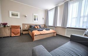 a bedroom with a bed and a couch at Stara Cynkownia in Czechowice-Dziedzice