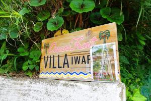 a sign for a villa waza on a wall at Minami bousou Ocean Front Vila Iwafune in Isumi