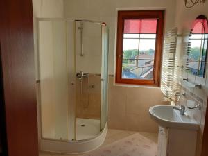 a bathroom with a shower and a sink at Apartamenty i pokoje u Beaty in Augustów +64 photos