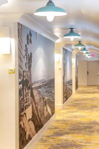 a hallway in a building with a painting on the wall at Ocean Park Inn in San Diego
