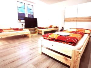 a bedroom with two beds and a flat screen tv at DIAMOND house in Brezno