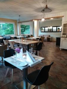 a restaurant with tables and chairs in a room at Haus S.E.E. in Marienthal