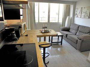 a kitchen and living room with a table and a couch at JSM Apartamentos in Benalmádena