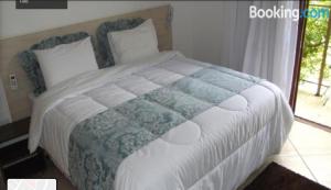 A bed or beds in a room at Hotel Nova Odessa
