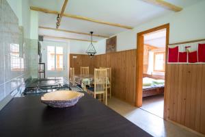 a kitchen with a black counter top in a room at Holiday Home Srednja vas in Srednja Vas v Bohinju
