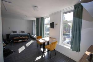 a room with a bed and a desk and a table at The Town hotel studios appartments in Zuidzande