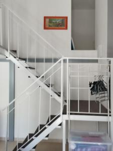 a staircase in a house with white rails at Appartamento SeaLife in San Foca