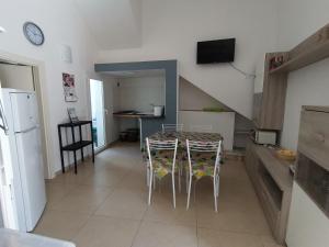 a kitchen and dining room with a table and chairs at Appartamento SeaLife in San Foca