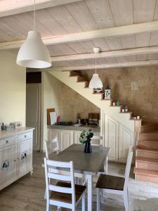 a kitchen with a table and chairs and a staircase at VILLA ERSILIA in Porto Columbu - Perdʼe Sali