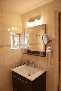 uma casa de banho com um lavatório e um espelho em B&B Brakke Berg em Berg en Terblijt