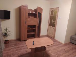 a room with a table and a book shelf at Rojas street apartments in Liepāja