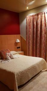 Postel nebo postele na pokoji v ubytování Hostal Milenium