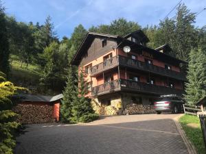 a large building with a car parked in front of it at Willa Kora in Szczyrk