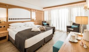 Кровать или кровати в номере Giardin Boutique Hotel B&B