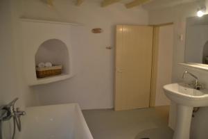 a bathroom with a sink and a tub and a toilet at Kastro in Parikia