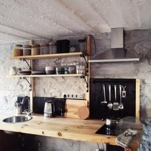 a kitchen with a counter top with a sink at Graide Retreat Lodge in Bièvre