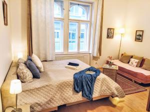 a bedroom with a large bed and a window at Apartments Historical Centre in Bratislava