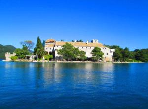 a house on an island in the middle of a lake at Villa Anita in Sobra +23 photos