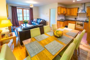 a kitchen and dining room with a table and chairs at Croagh Patrick Hostel & Cottages Resort in Murrisk