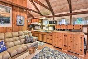 a living room with a couch and a kitchen at Newland Cottage 3 Miles to Grandfather Mtn Park! in Newland