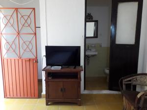 a room with a door and a television on a table at Hotel Ana Liz in Puerto Vallarta