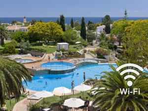 a view of a pool with people in a resort at Rocha Brava Village Resort in Carvoeiro