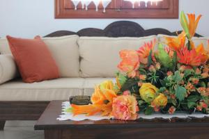 a bouquet of flowers on a coffee table in a living room at Galini in Agia Irini Milos
