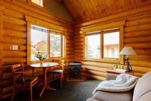 a living room filled with furniture and a window at Miette Mountain Cabins in Jasper