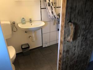 a bathroom with a sink and a toilet at Pension Restaurant Ewald in Bischofsheim an der Rhön +60 photos