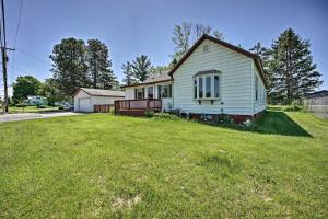 a white house in a yard with a grass field at 3 Mi to Lake Michigan Access Sawyer Home with Patio in Sawyer