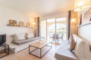 a living room with a couch and a table at Village Pierre & Vacances Pont Royal en Provence in Mallemort