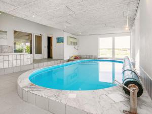a large swimming pool in a large room with a large window at 10 person holiday home in Hals in Hou